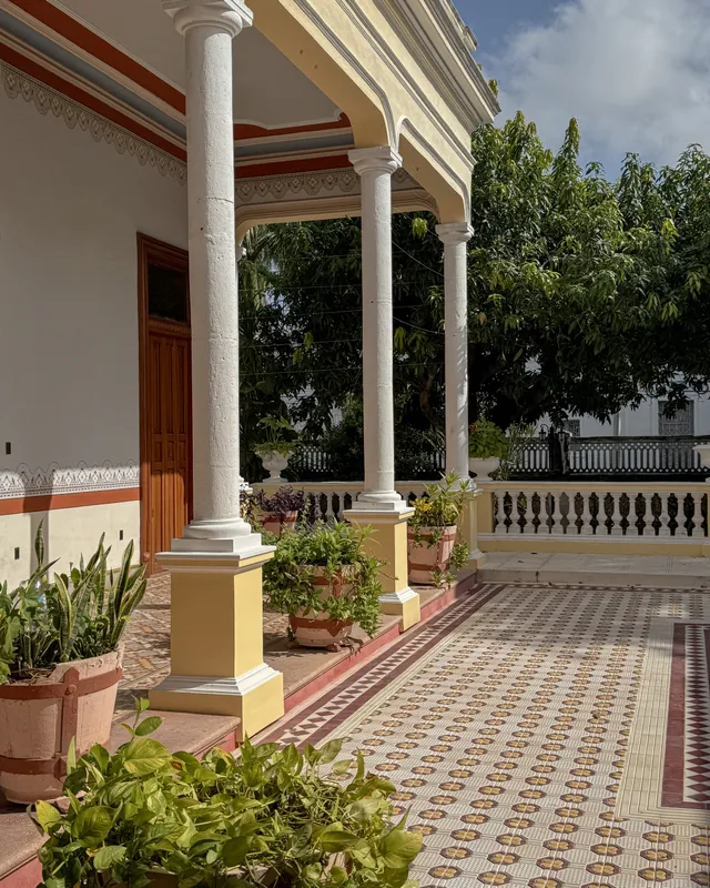 Colonnaded walkway with patterned tile floors around the central courtyard