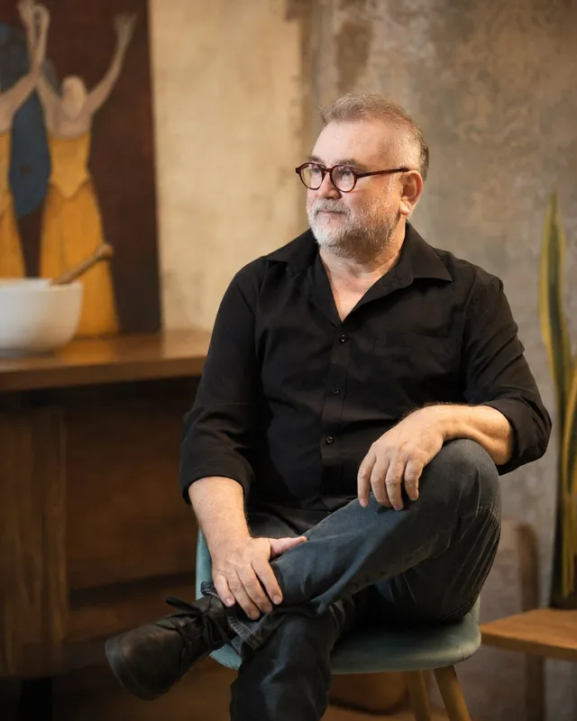 Portrait of Javier Barrera seated in his studio