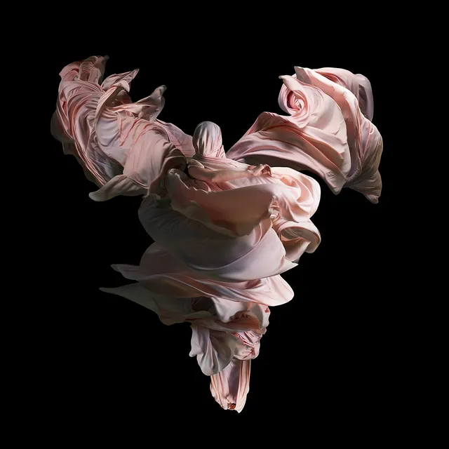 Performative photograph by Lizette Abraham: figure wrapped in pink fabrics